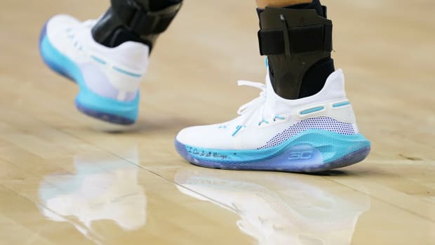 View of white and blue Under Amour shoes.